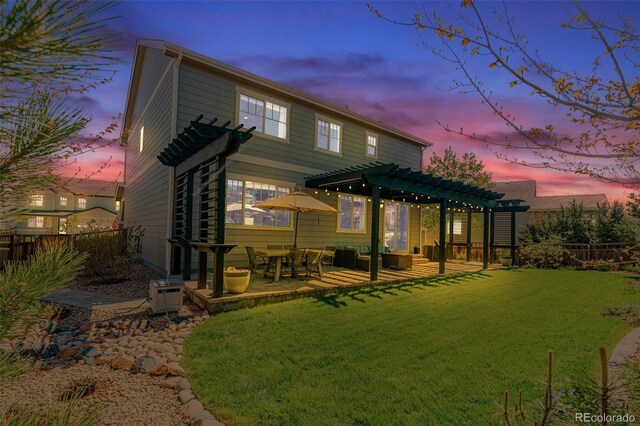 back of house at dusk with a pergola and a patio area