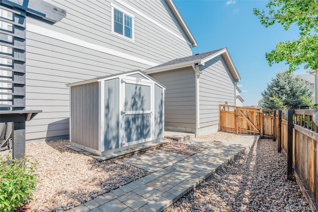 view of shed with a gate and fence