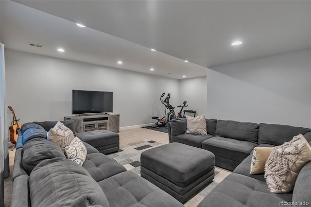 living area with recessed lighting, light carpet, and baseboards