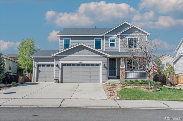craftsman inspired home featuring a garage, covered porch, and driveway