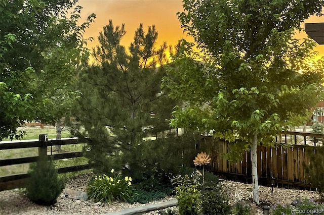 gate at dusk featuring fence
