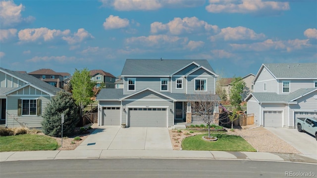 craftsman-style house with concrete driveway, a residential view, covered porch, and a garage