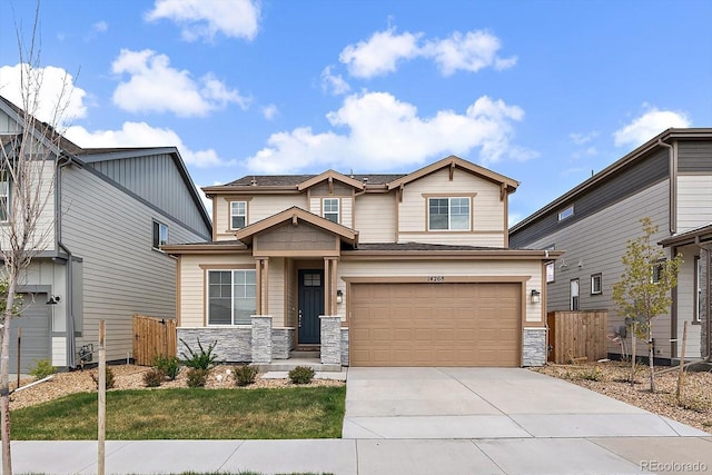 view of front of home with fence, an attached garage, driveway, and stone siding