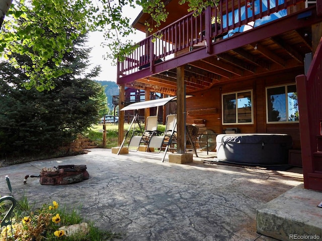 view of patio featuring a fire pit and a wooden deck