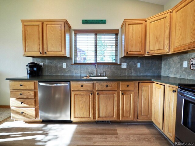 kitchen with dark hardwood / wood-style flooring, sink, decorative backsplash, vaulted ceiling, and stainless steel dishwasher