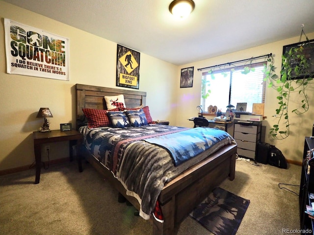 carpeted bedroom featuring baseboards