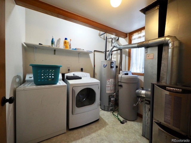 washroom with water heater, laundry area, and washing machine and clothes dryer