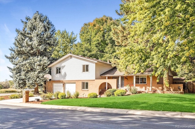 split level home featuring a front lawn and a garage