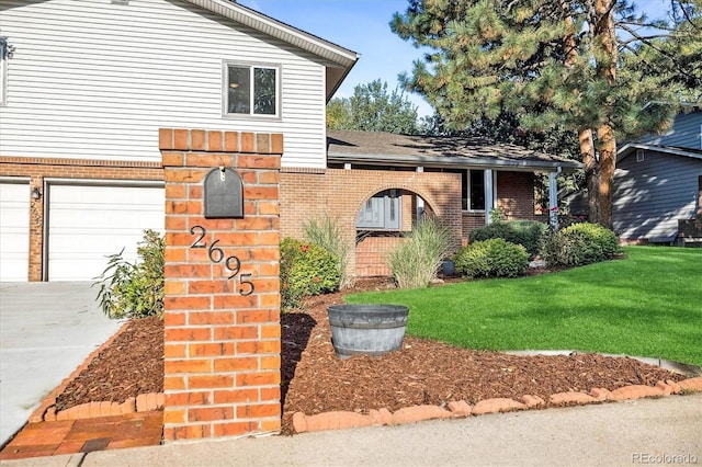 view of front facade with a front yard and a garage