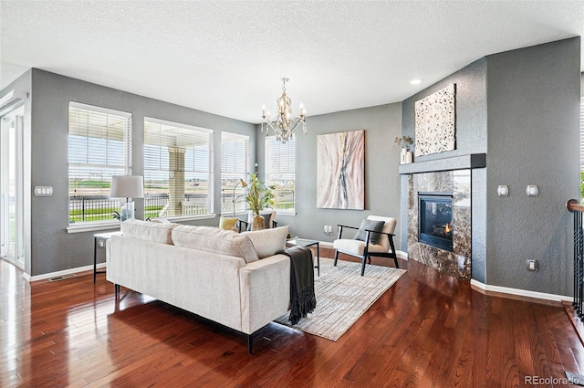 7426 E 148th Pl, Thornton, CO 80602 - living area featuring baseboards, wood finished floors, a fireplace, a textured ceiling, and a textured wall