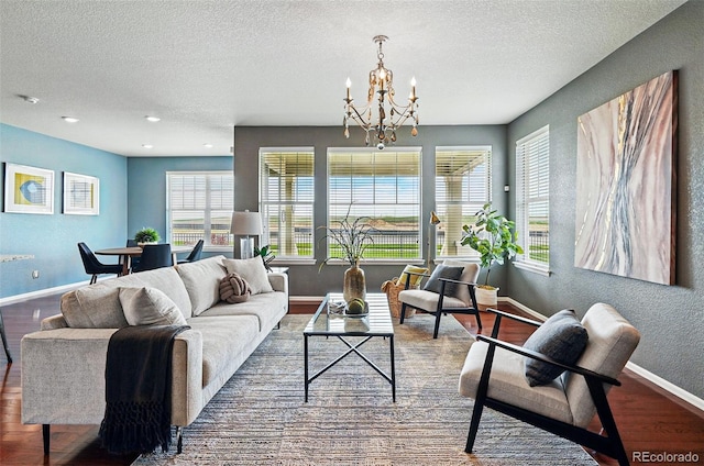 7426 E 148th Pl, Thornton, CO 80602 - living area featuring baseboards, a chandelier, wood finished floors, a textured ceiling, and a textured wall