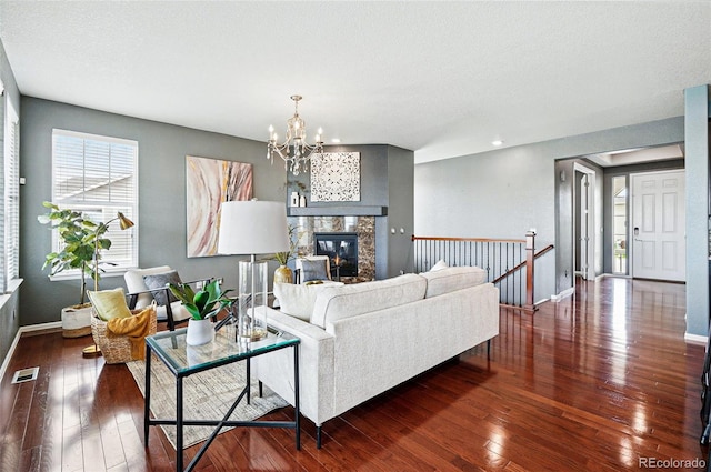 7426 E 148th Pl, Thornton, CO 80602 - living room featuring a chandelier, hardwood / wood-style floors, baseboards, recessed lighting, and a glass covered fireplace