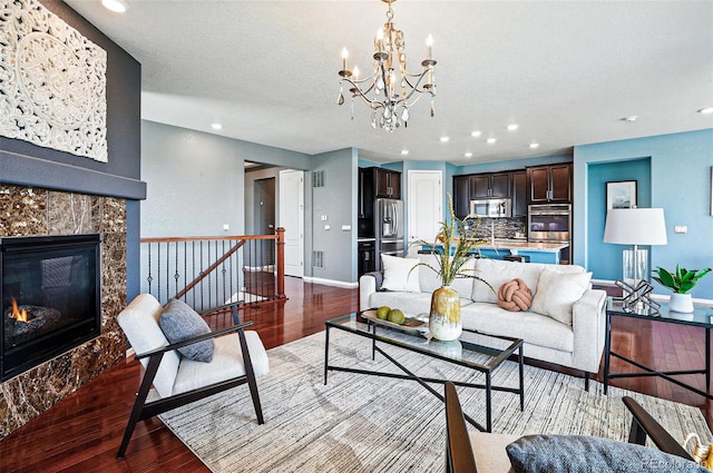 7426 E 148th Pl, Thornton, CO 80602 - living room with wood finished floors, recessed lighting, a chandelier, baseboards, and a premium fireplace