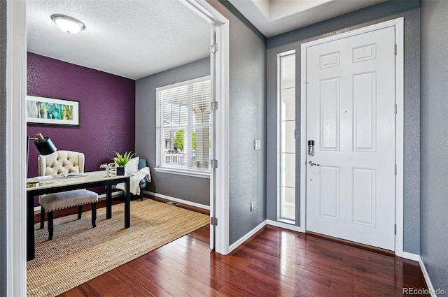 7426 E 148th Pl, Thornton, CO 80602 - entrance foyer featuring dark wood-type flooring, baseboards, and a textured wall
