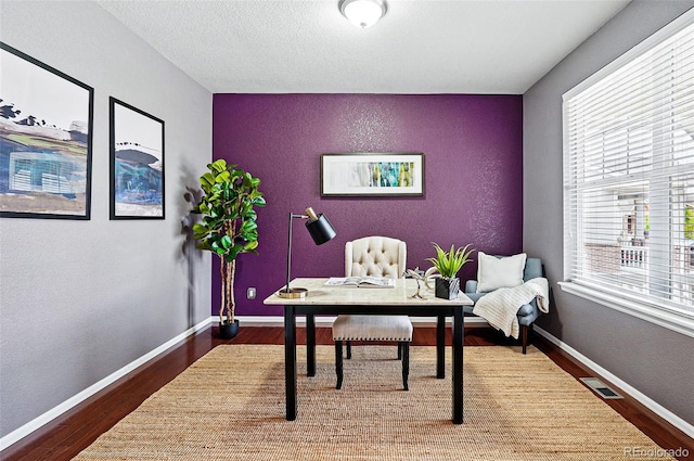 7426 E 148th Pl, Thornton, CO 80602 - office space with wood finished floors, an accent wall, and baseboards
