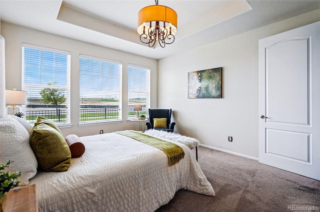 7426 E 148th Pl, Thornton, CO 80602 - bedroom with carpet flooring, a chandelier, baseboards, and a raised ceiling