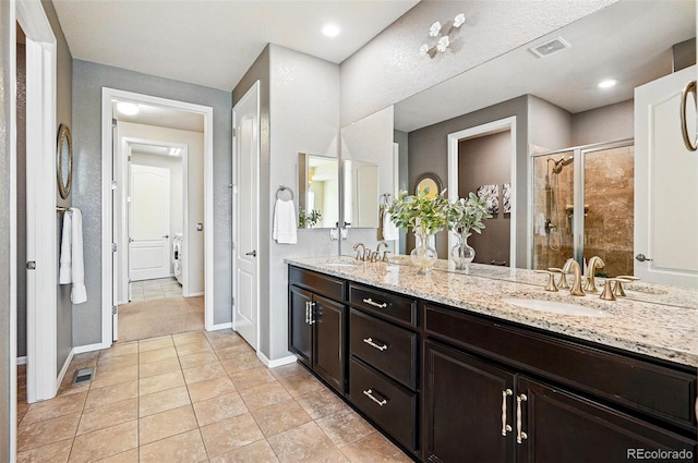 7426 E 148th Pl, Thornton, CO 80602 - full bath with a shower stall, tile patterned floors, baseboards, and double vanity