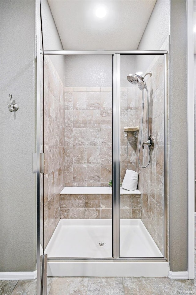 7426 E 148th Pl, Thornton, CO 80602 - full bath featuring a shower stall, a textured wall, and baseboards