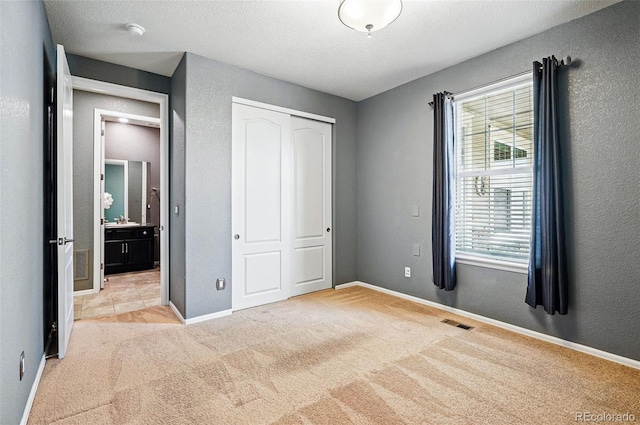 7426 E 148th Pl, Thornton, CO 80602 - unfurnished bedroom featuring light colored carpet, a closet, baseboards, and a textured ceiling