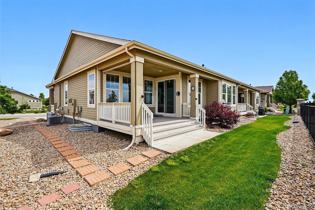 7426 E 148th Pl, Thornton, CO 80602 - rear view of property with covered porch, cooling unit, and a yard