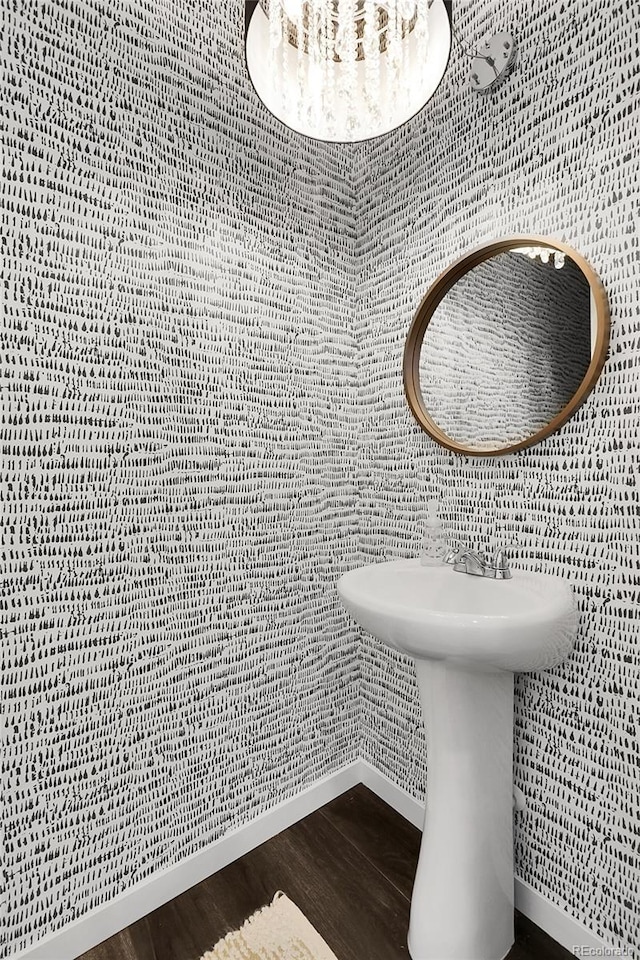 bathroom with baseboards and wood finished floors