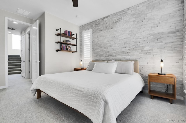 carpeted bedroom featuring a ceiling fan and visible vents