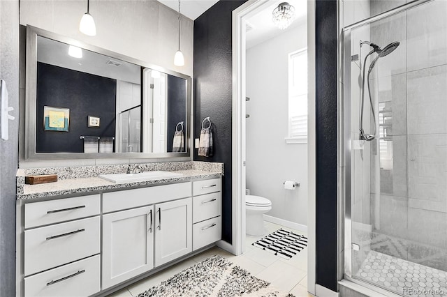 full bathroom with vanity, toilet, baseboards, and a stall shower