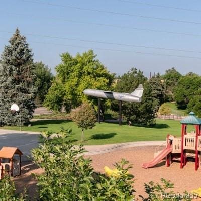 view of jungle gym featuring a lawn