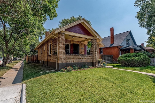 view of front facade with covered porch and a front yard