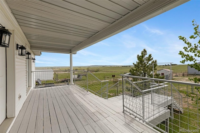 wooden terrace featuring a view of countryside