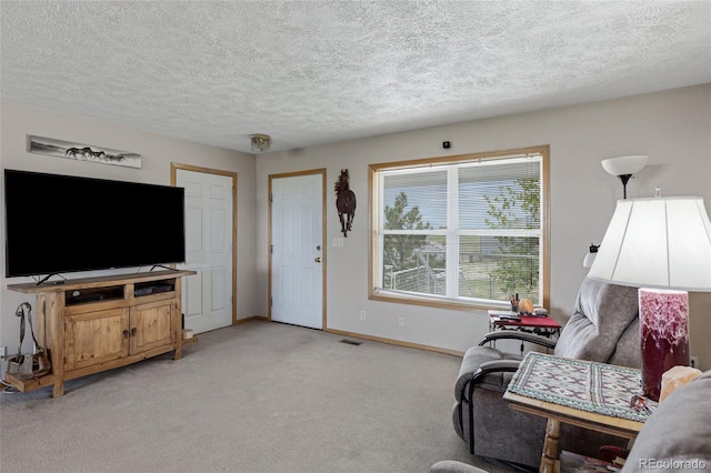 living room featuring light colored carpet, a textured ceiling, and baseboards