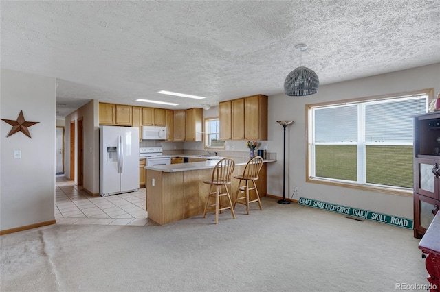 kitchen with white appliances, a peninsula, light carpet, baseboards, and a textured ceiling