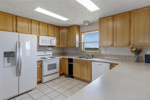 kitchen featuring white appliances, a sink, light countertops, a textured ceiling, and light tile patterned flooring