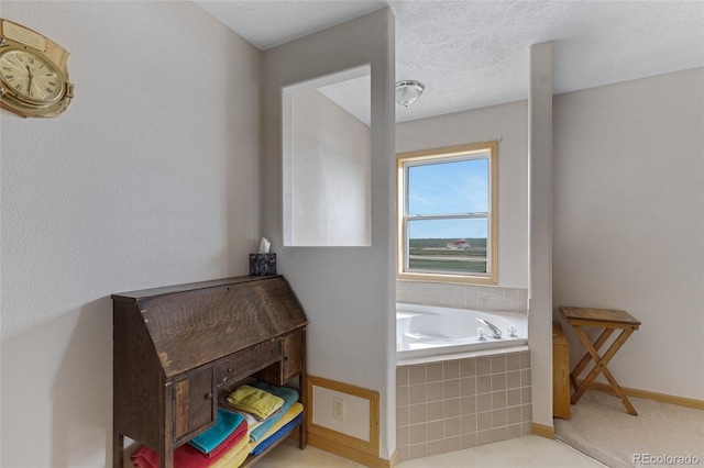 bathroom featuring baseboards and a bath