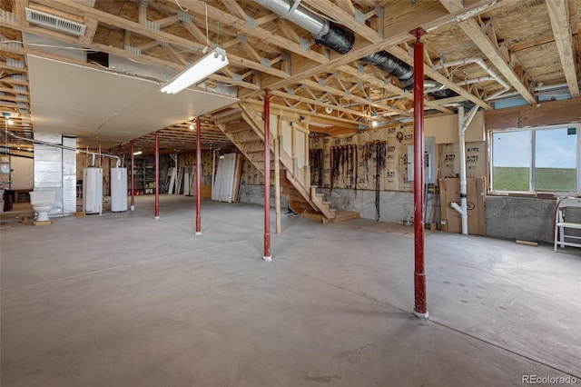 below grade area featuring water heater, stairs, and electric panel