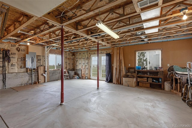basement featuring healthy amount of natural light and electric panel