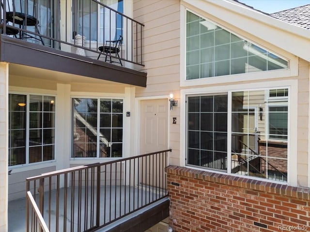 13873 E Lehigh Ave Unit E, Aurora, CO 80014 - entrance to property with a balcony and brick siding