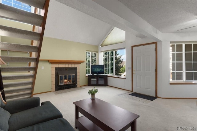 13873 E Lehigh Ave Unit E, Aurora, CO 80014 - carpeted living area featuring stairway, a fireplace, and lofted ceiling