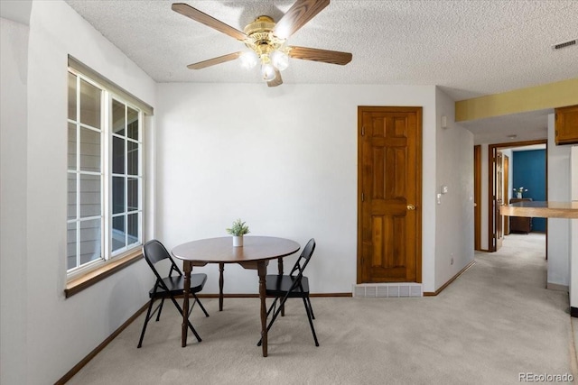 13873 E Lehigh Ave Unit E, Aurora, CO 80014 - dining room with a textured ceiling, light carpet, and ceiling fan