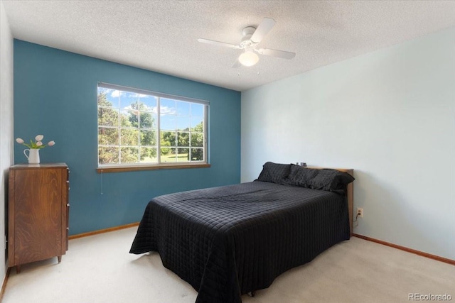 13873 E Lehigh Ave Unit E, Aurora, CO 80014 - bedroom with carpet floors, a textured ceiling, and ceiling fan