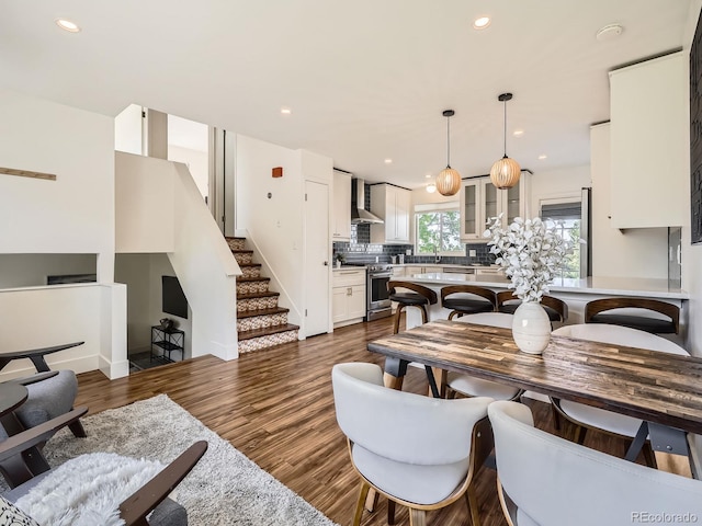 9430 Carr St, Westminster, CO 80021 - living area featuring recessed lighting, dark wood-type flooring, stairway, and baseboards