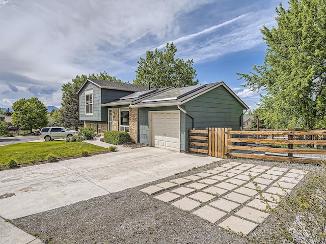 9430 Carr St, Westminster, CO 80021 - view of front of property with concrete driveway, a garage, brick siding, and roof with shingles