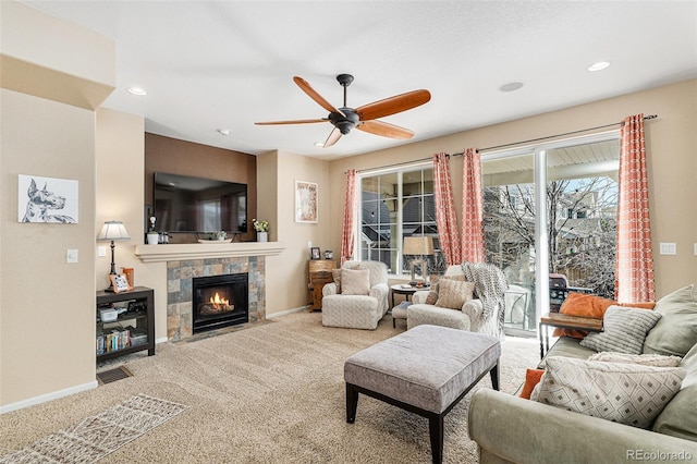 carpeted living room featuring ceiling fan, recessed lighting, a fireplace, visible vents, and baseboards