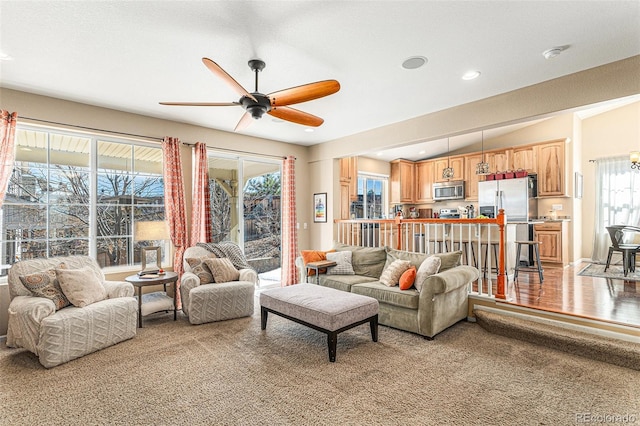 living room featuring light carpet, ceiling fan, and recessed lighting