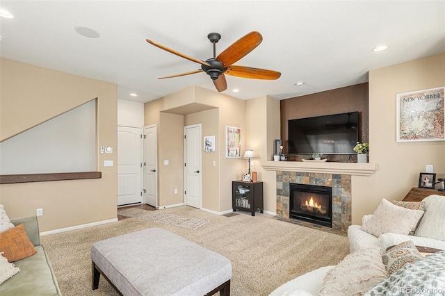 carpeted living area featuring recessed lighting, a fireplace, baseboards, and ceiling fan