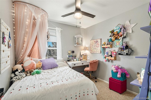 carpeted bedroom with ceiling fan and baseboards