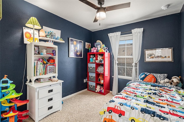 carpeted bedroom featuring ceiling fan and baseboards