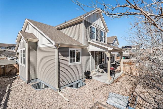 view of home's exterior featuring roof with shingles, a patio area, and a fenced backyard