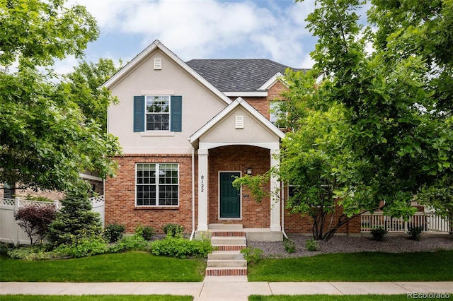 8122 E 6th Pl, Denver, CO 80230 - traditional-style house with brick siding, stucco siding, and roof with shingles