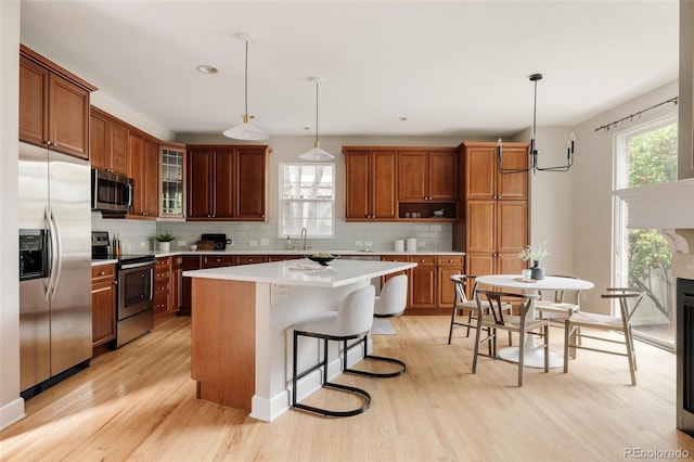 8122 E 6th Pl, Denver, CO 80230 - kitchen with stainless steel appliances, a sink, light countertops, light wood finished floors, and recessed lighting